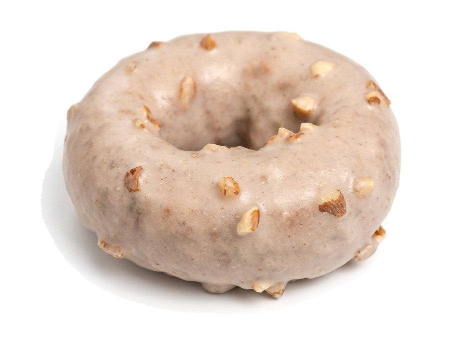 Banana bread doughnut topped with chopped pecans
